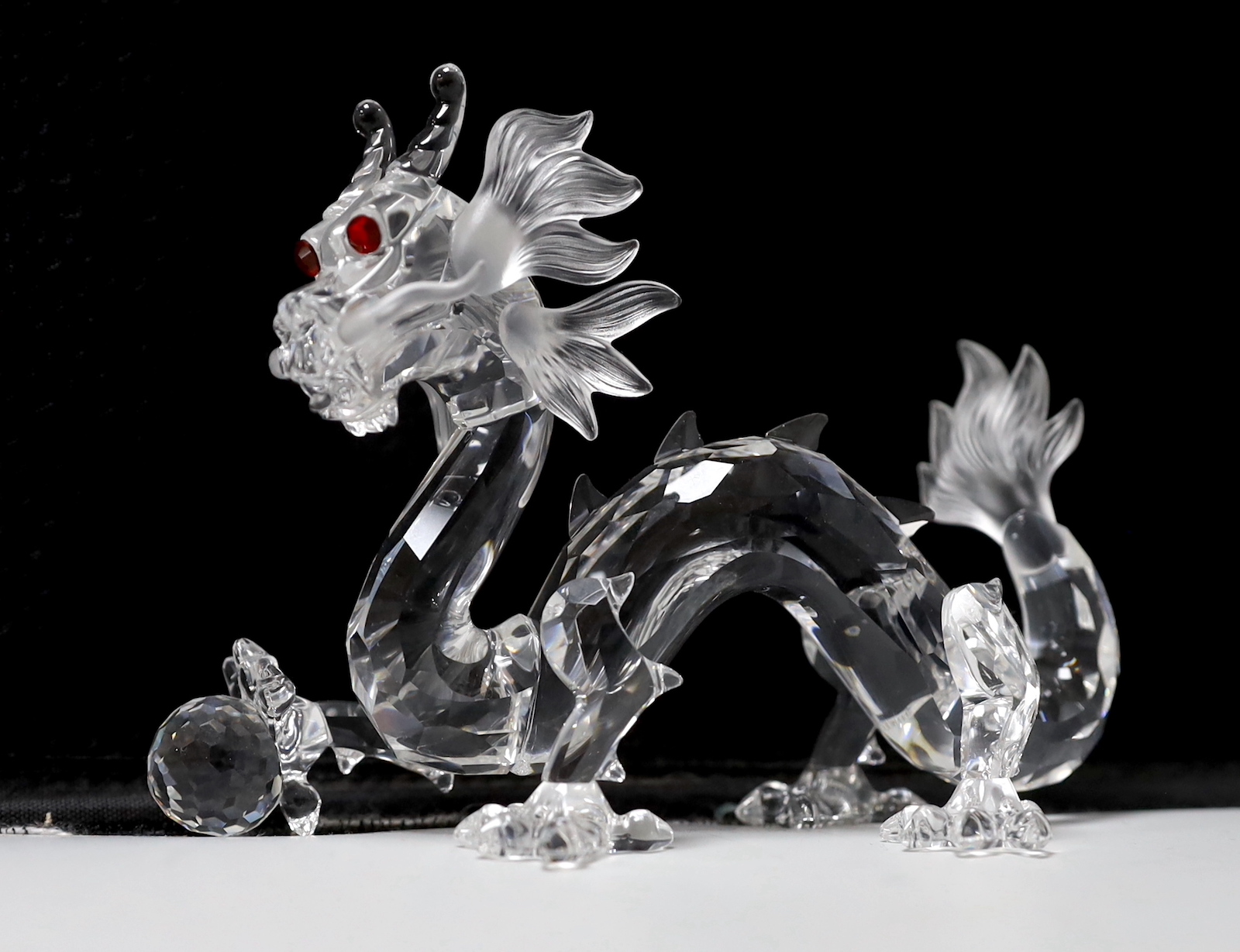 Three Swarovski Crystal figures comprising Pegasus, unicorn and dragon, each with boxes and booklets, the largest 15cm wide